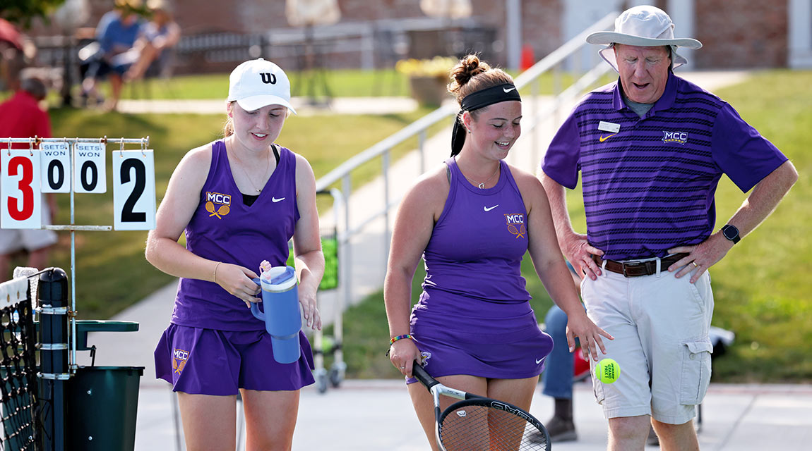 Scots women's tennis players Elaina Hibbeler and Isabelle Rodrigue stand with Head Coach Jim Stockwell.