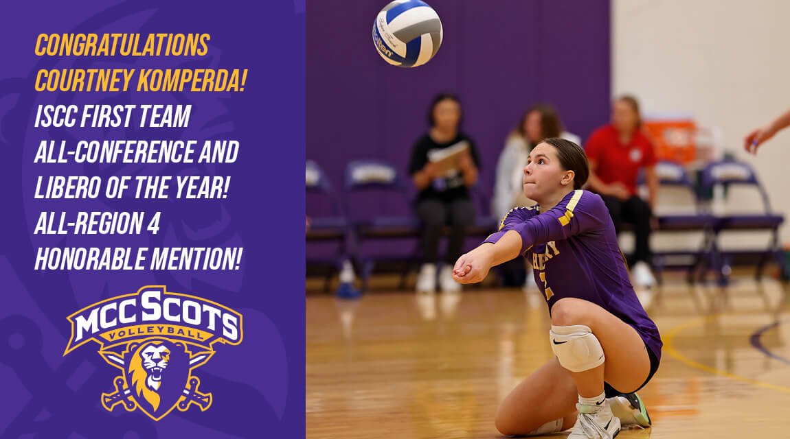 Volleyball player Courtney Komperda, wearing a purple uniform, is preparing to receive the ball during a game on a gym court.
